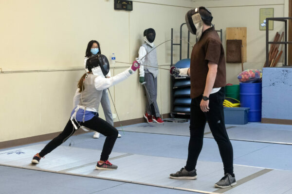 Olympics fencing athletes train with coach at South Denver Fencing Academy.